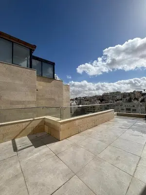 a balcony of a building with a view of a city at شقة مميزة في عبدون هيلز-Modern Apartment in Abdoun Hills in Amman