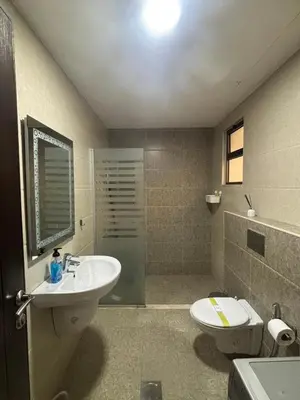 a bathroom with a sink and a toilet at شقة مميزة في عبدون هيلز-Modern Apartment in Abdoun Hills in Amman