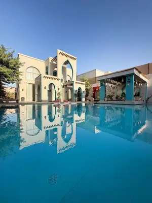 a large swimming pool in front of a building at Sultana Villa by Seahorse in Al Rama