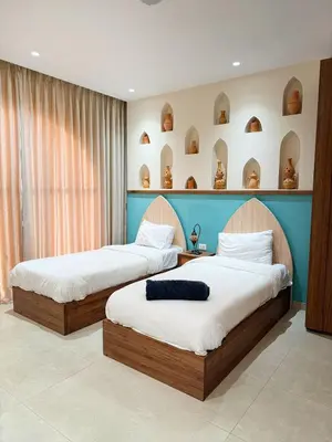 two beds in a hotel room with two at Sultana Villa by Seahorse in Al Rama