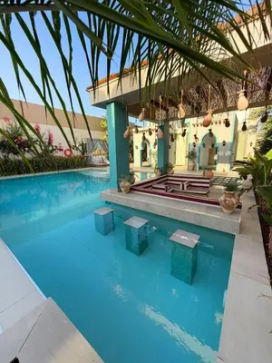 a house with a swimming pool with a building at Sultana Villa by Seahorse in Al Rama