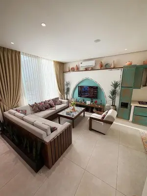 a living room with two couches and a table at Sultana Villa by Seahorse in Al Rama