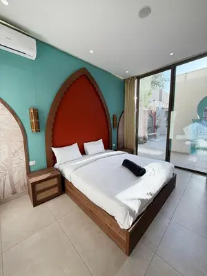 a bedroom with a large bed with a large headboard at Sultana Villa by Seahorse in Al Rama