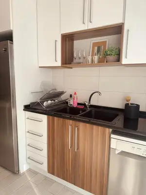 a kitchen with a sink and a refrigerator at 24h security, family friendly remodeled cozy space in Amman