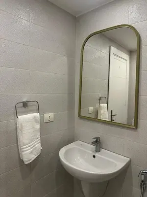 a bathroom with a sink and a mirror at 24h security, family friendly remodeled cozy space in Amman