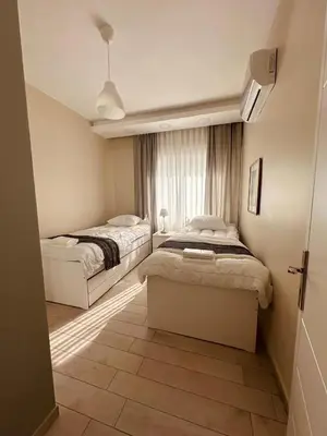 a bedroom with two beds and a window at 24h security, family friendly remodeled cozy space in Amman