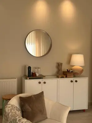 a living room with a mirror and a couch at 24h security, family friendly remodeled cozy space in Amman