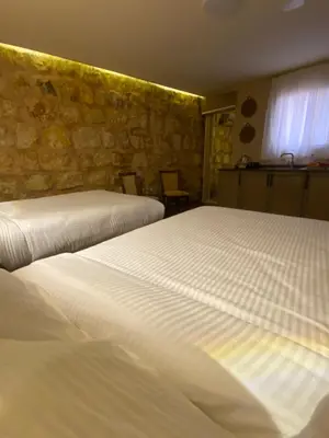 two beds sitting next to each other in a room at Petra Gateway Guest Room in Wadi Musa
