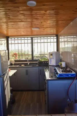 a kitchen with a sink and a stove top oven at Um Al Namel Villa & Chalet
