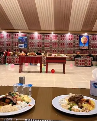 two plates of food on a table in a restaurant at Isabella Desert Camp & Tour in Wadi Rum