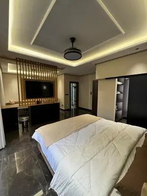 a large bedroom with a large bed and a desk at Modern apartment near the UK embassy in abdoun in Amman