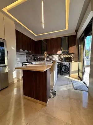 a kitchen with a large island in the middle at Modern apartment near the UK embassy in abdoun in Amman