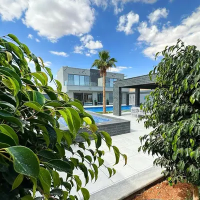 a house with a pool and a palm tree at La Mer Villa by Seahorse in Al Rama