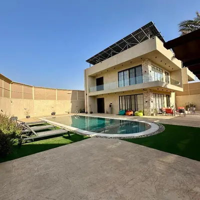 a house with a swimming pool in front of it at Tonay I Villa by Seahorse in Al Rama