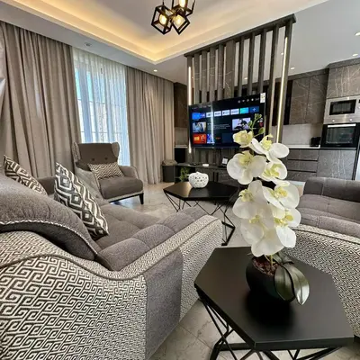 a living room with a couch and a tv at Tonay I Villa by Seahorse in Al Rama