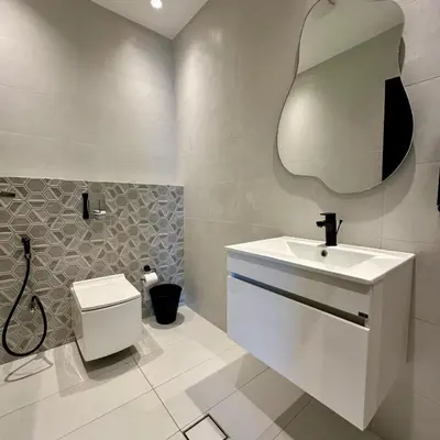 a bathroom with a sink and a toilet and a mirror at Tonay I Villa by Seahorse in Al Rama