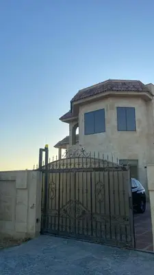 a house with a gate in front of it at Appartment in Amman within a villa