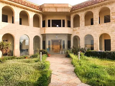 a large building with a walkway in front of it at Appartment in Amman within a villa