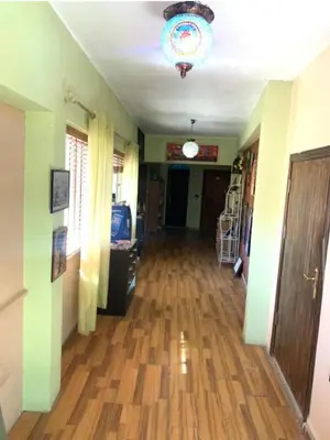 a hallway with a hard wood floor and a ceiling at Petra Neighbor Hostel in Petra