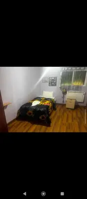 a bedroom with a bed in the corner of a room at Petra Neighbor Hostel in Petra