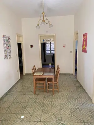 a dining room with a table and chairs at Stylish 2BR Apartment, Walkable Jabal Al-Weibdeh in Amman