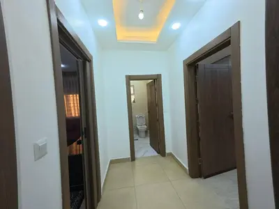 a hallway with two doors leading to a bathroom at 220 sqm 3 BR Um Al Summag, Makka Street