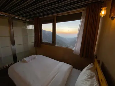 a bedroom with two beds and a window at Dana Trail Nomad Camp in Dana