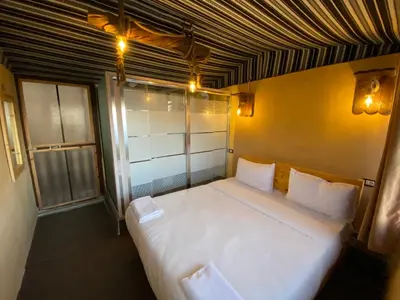 a bedroom with a large white bed in a room at Dana Trail Nomad Camp in Dana