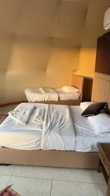 two beds sitting next to each other in a room at sayd camp in Wadi Rum