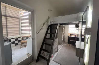a room with a bunk bed and a ladder at Modern Loft Studio Panoramic Views And Smart Design in Amman