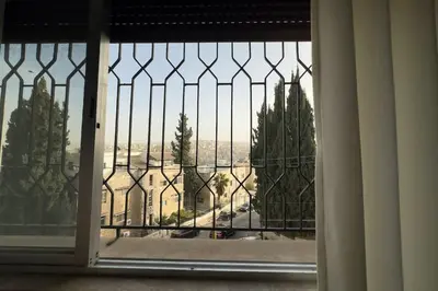 an open window with a view of a building at Modern Loft Studio Panoramic Views And Smart Design in Amman