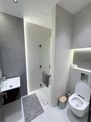 a bathroom with a toilet and a sink and a shower at Luxury 3-Bedroom Apartment in Amman