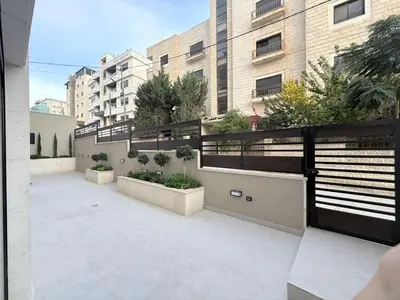 a balcony with plants on the side of a building at Luxury 3-Bedroom Apartment in Amman