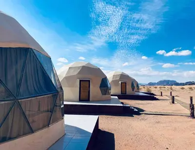 a group of three domed tents in the desert at Wadi Rum Ahmad comp in Wadi Rum