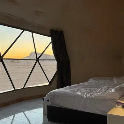 a bedroom with a bed and a view of the ocean at Wadi Rum Ahmad comp in Wadi Rum
