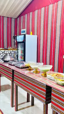 a kitchen with a table with food on it at Wadi Rum Ahmad comp in Wadi Rum