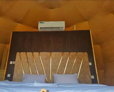 a bed with a box on top of it at Wadi Rum Ahmad comp in Wadi Rum
