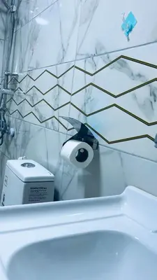 a white bathroom with a black and white tile wall at Wadi Rum Ahmad comp in Wadi Rum