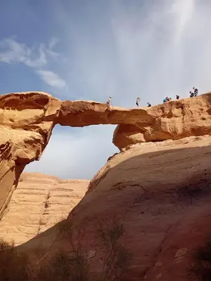 a group of people standing on top of a rock formation at Wadi rum bubble camp in Wadi Musa