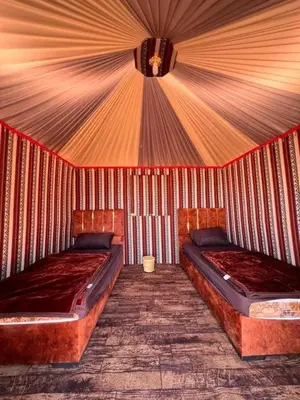 a room with two beds in a tent at Star Desert Camp in Wadi Rum
