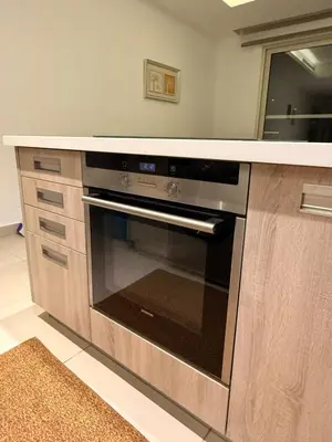 a kitchen with a stainless steel oven in a kitchen at 2 BR 100 sqm Modern Apt Abdoun in Amman