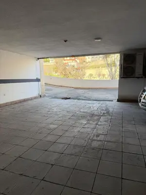 an empty parking garage with a large open door at 2 BR 100 sqm Modern Apt Abdoun in Amman