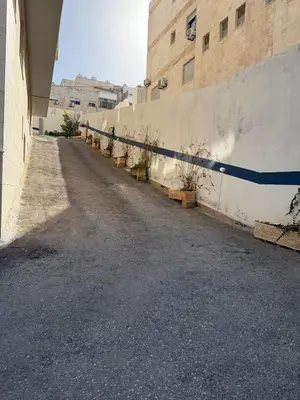 an empty street next to a wall with plants at 2 BR 100 sqm Modern Apt Abdoun in Amman