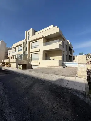 a large building on the side of a street at 2 BR 100 sqm Modern Apt Abdoun in Amman