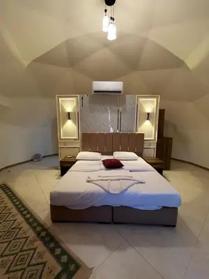 a bedroom with a large bed and two mirrors at Imperial Rum Luxury Camp in Wadi Rum