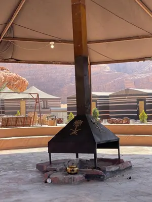 a stage in a building with mountains in the background at Red Moon Camp in Wadi Rum