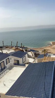 a view of blue solar panels on top of a house at Santorini Resort & Spa in Sowayma