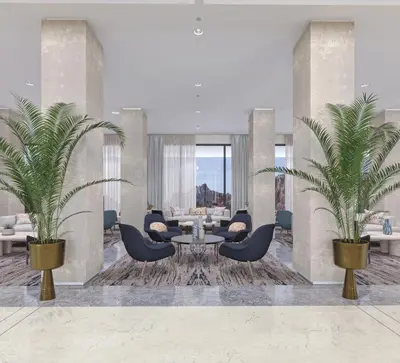 a living room with two palm trees and a table and chairs at Crowne Plaza Resort Petra by IHG in Wadi Musa