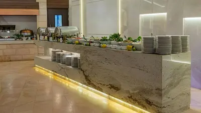 a kitchen with plates and dishes on a counter at Crowne Plaza Resort Petra by IHG in Wadi Musa
