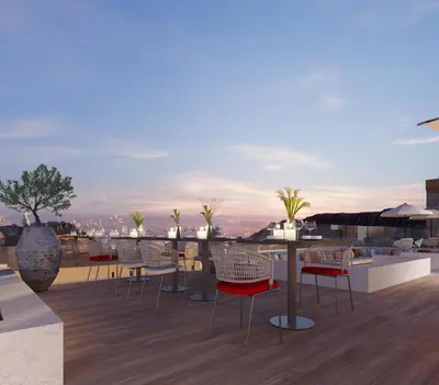 a patio with tables and chairs on a roof at Crowne Plaza Resort Petra by IHG in Wadi Musa